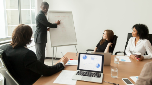 african-american-businessman-giving-presentation-explaining-new-marketing-plan-meeting-scaled-1